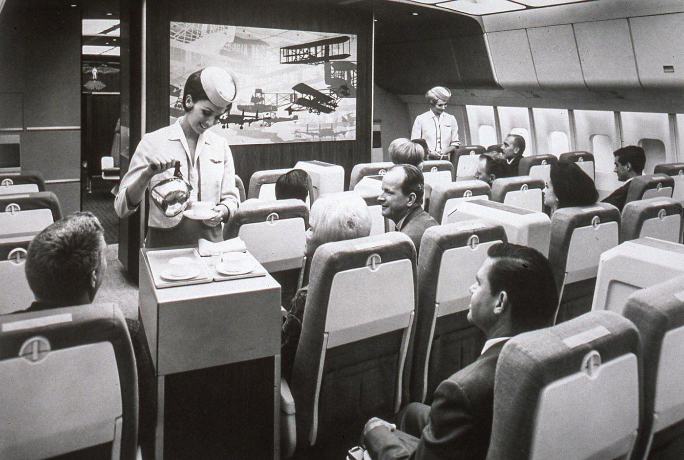 Passengers and flight attendants inside a mock-up interior of a Lockheed L-1011 TriStar passenger aircraft during its development work and design in the United States in 1968.