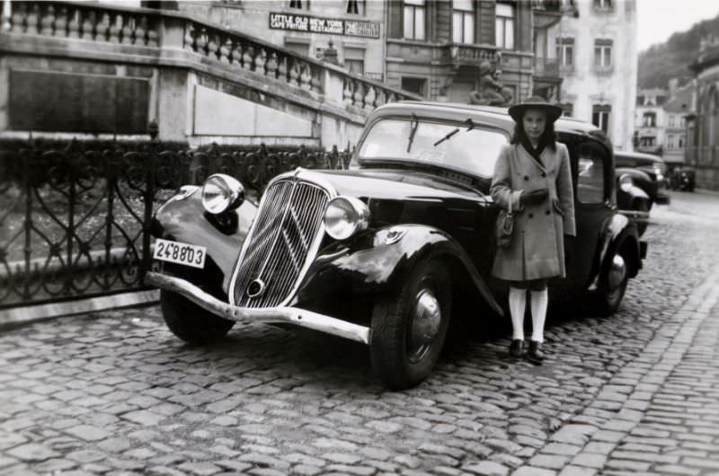 Girl with Citroën Traction Avant in cobbled street, 1948