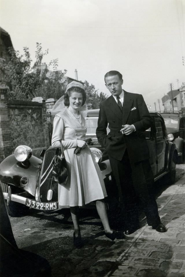 Lady and man with Citroën 11 CV in residential street, Paris registration, 1955