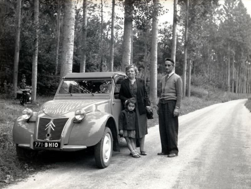 Three members of a French family with Citroën 2 CV on roadside, Aube registration, 1955