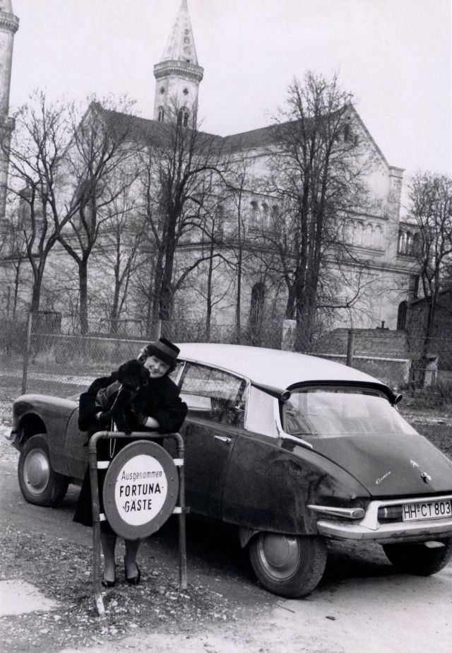 Lady with poodle and Citroën DS on access road to hotel or sanatorium, Hamburg registration, 1962
