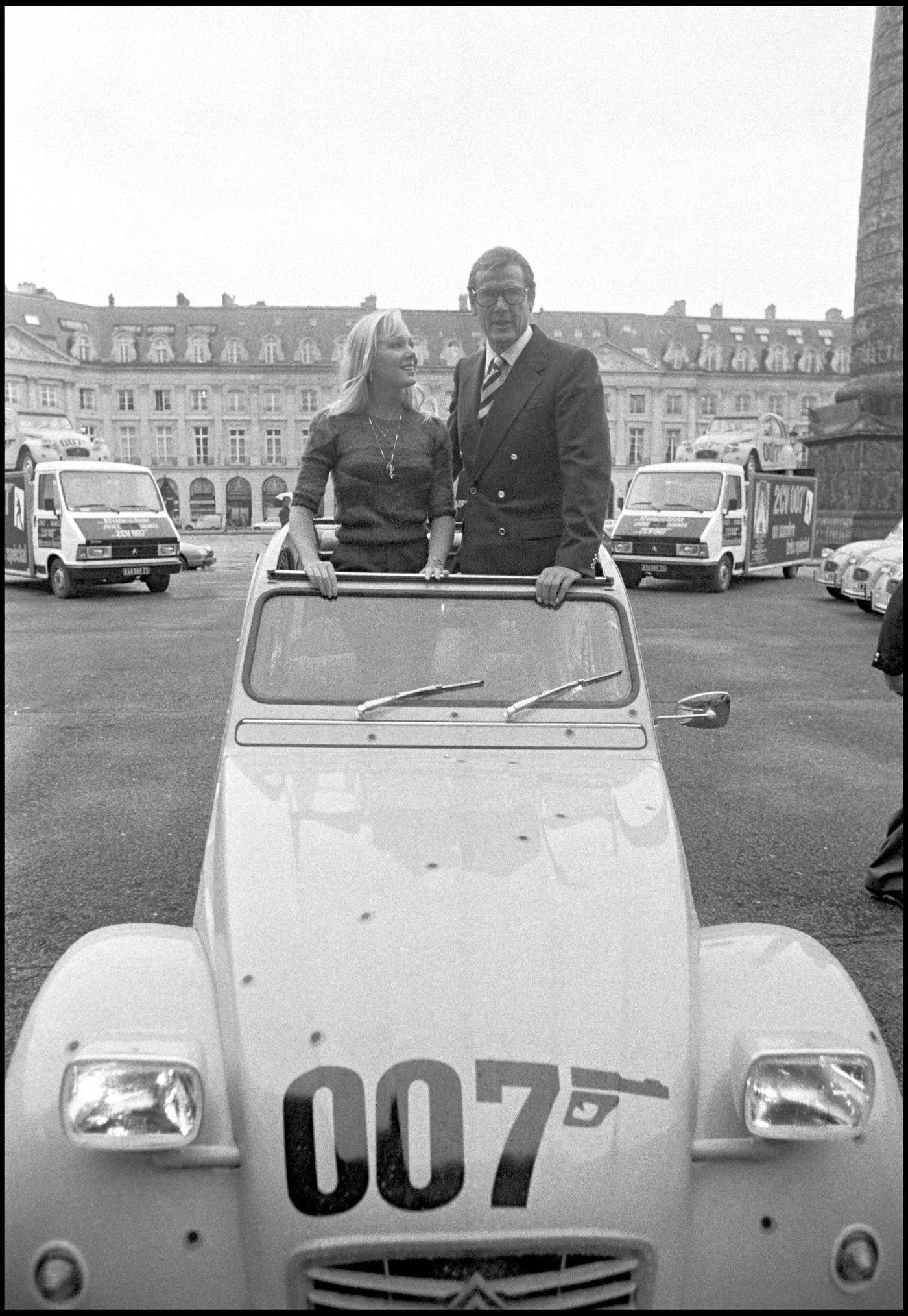 Roger Moore promoting "For Your Eyes Only" with a Citroen 2CV on Vendome Plaza in Paris.