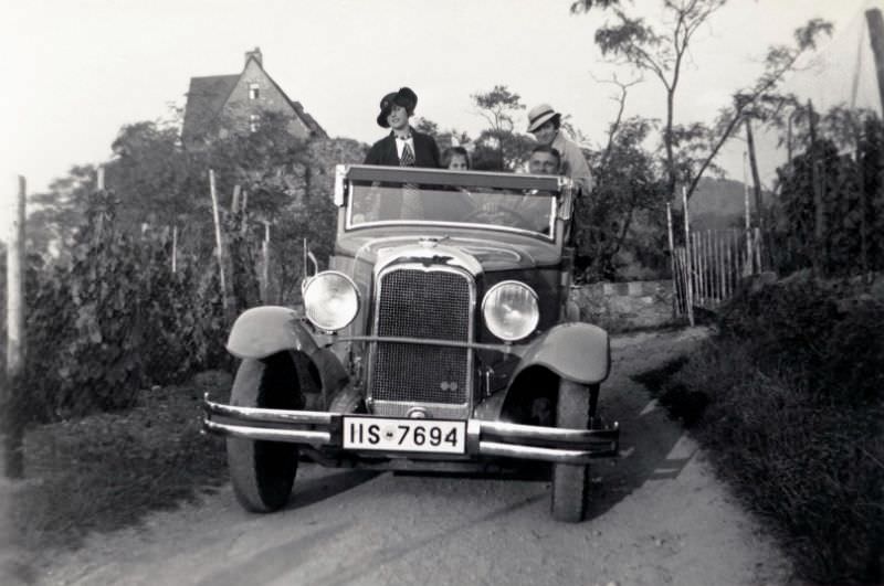 Group in Citroën C4 Cabriolet in vineyards, 1932