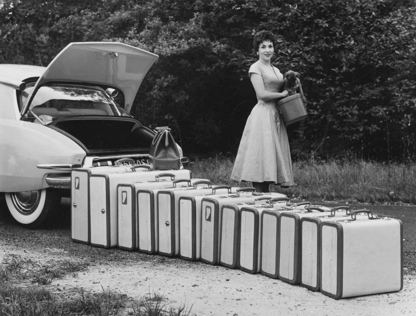 Italian Actress Gina Lo, known for its innovative suspension and use of plastic in its construction.llobrigida Standing Beside Suitcases in a Citroen DS 19, 1955.