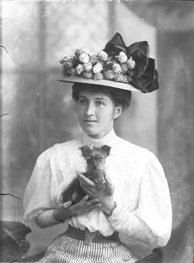 Miss Marston poses with her dog for a portrait on October 1, 1908