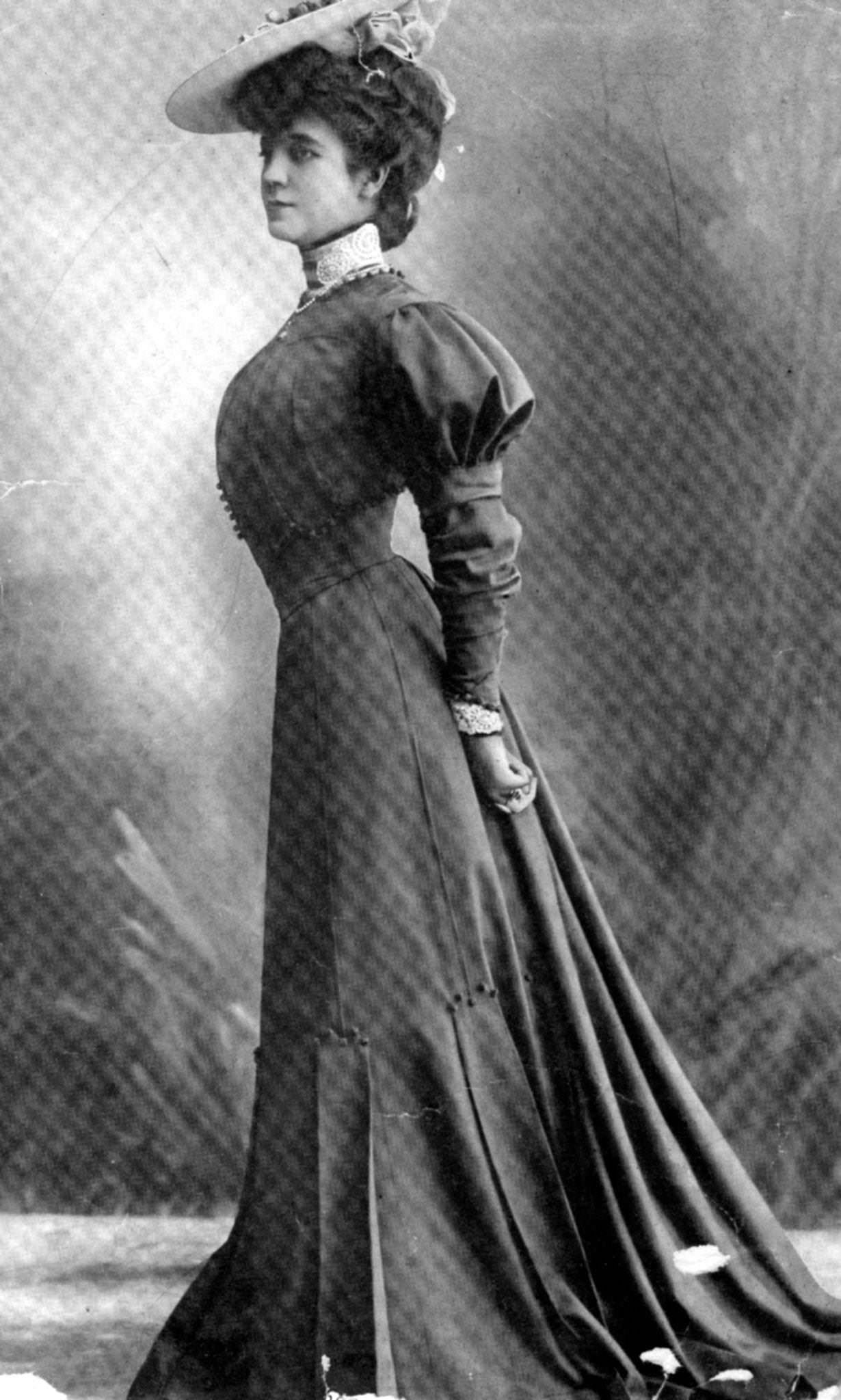 An Edwardian woman models a street dress in the typical style of the period in 1905