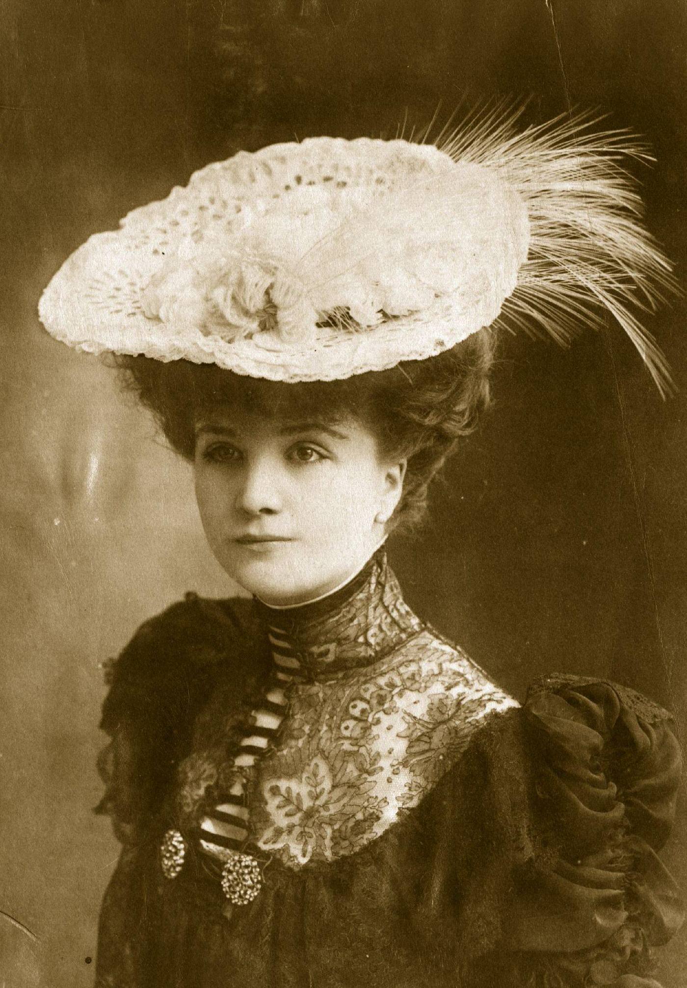 An elegant white lace hat with feather trimming from the Edwardian era