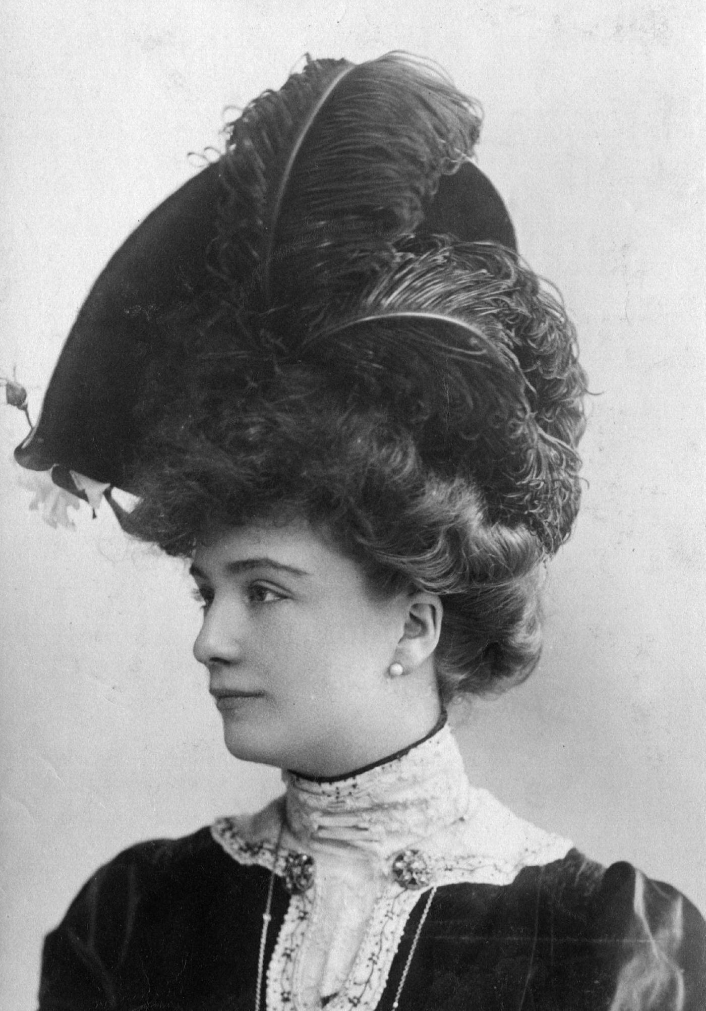 An Edwardian woman looks stunning in an ostrich feather hat in 1903