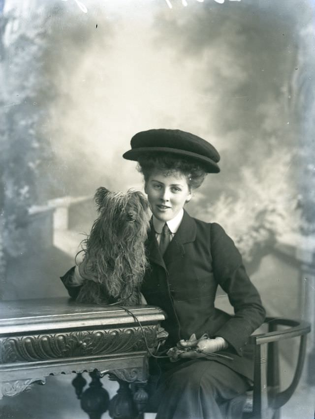 Miss Taylor poses with her dog for a portrait in 1906