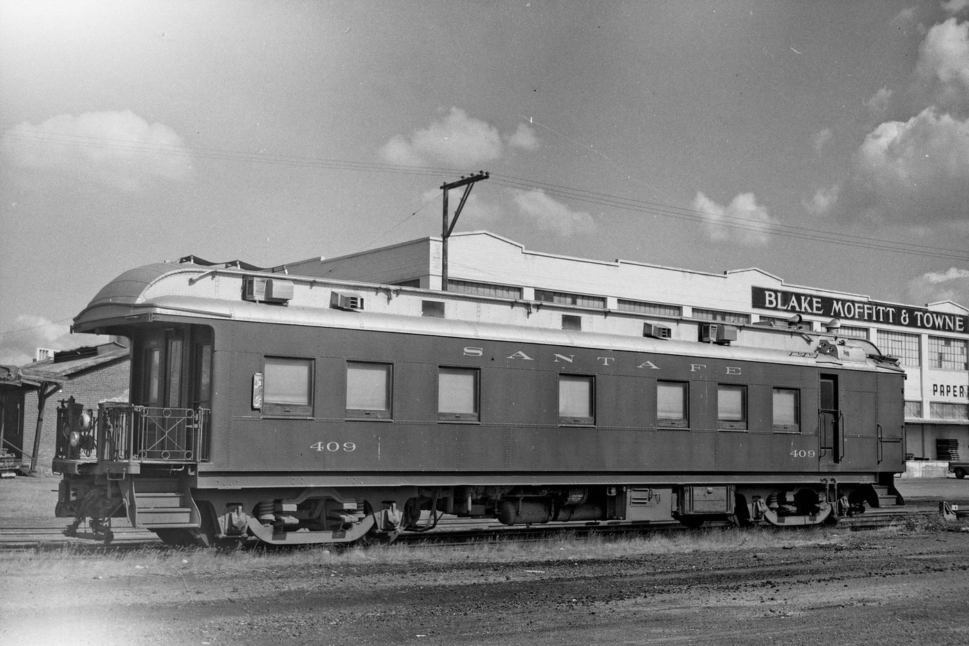 Antique rail car parked on a siding in Fresno, California, 1960s