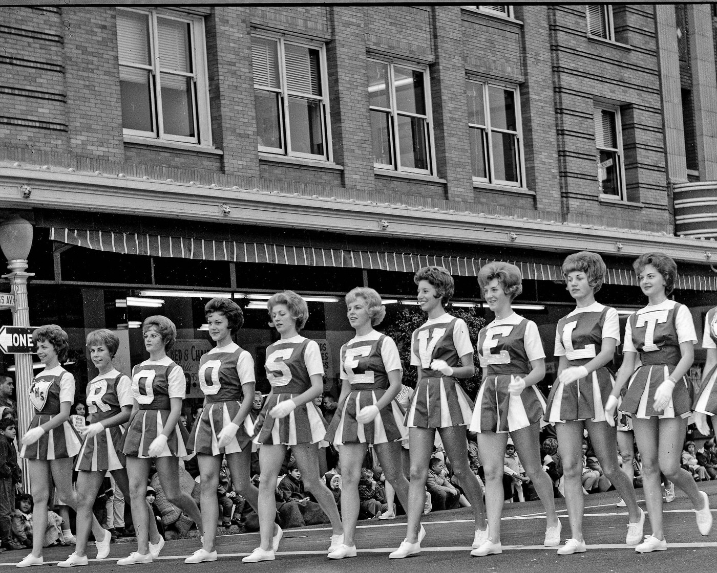 On Van Ness at the Tulare Street intersection in Fresno, California. The Chester Rowell Building is in the background. These are the Roosevelt High School letter girls.