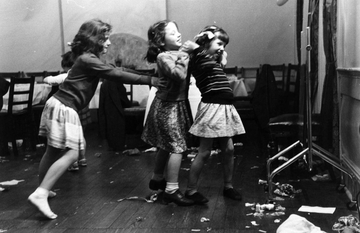 Some of the Hudson family's twenty children enjoying themselves at a Christmas lunch in Selfridges department store, London, 1953