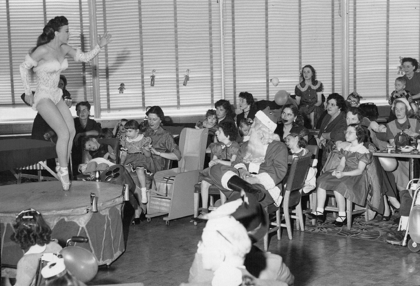 Regina Day executes a light, rhythmic toe-tap dance routine on a drum to entertain about 100 exceptional children who were guests at a Christmas party at the Park Lane.