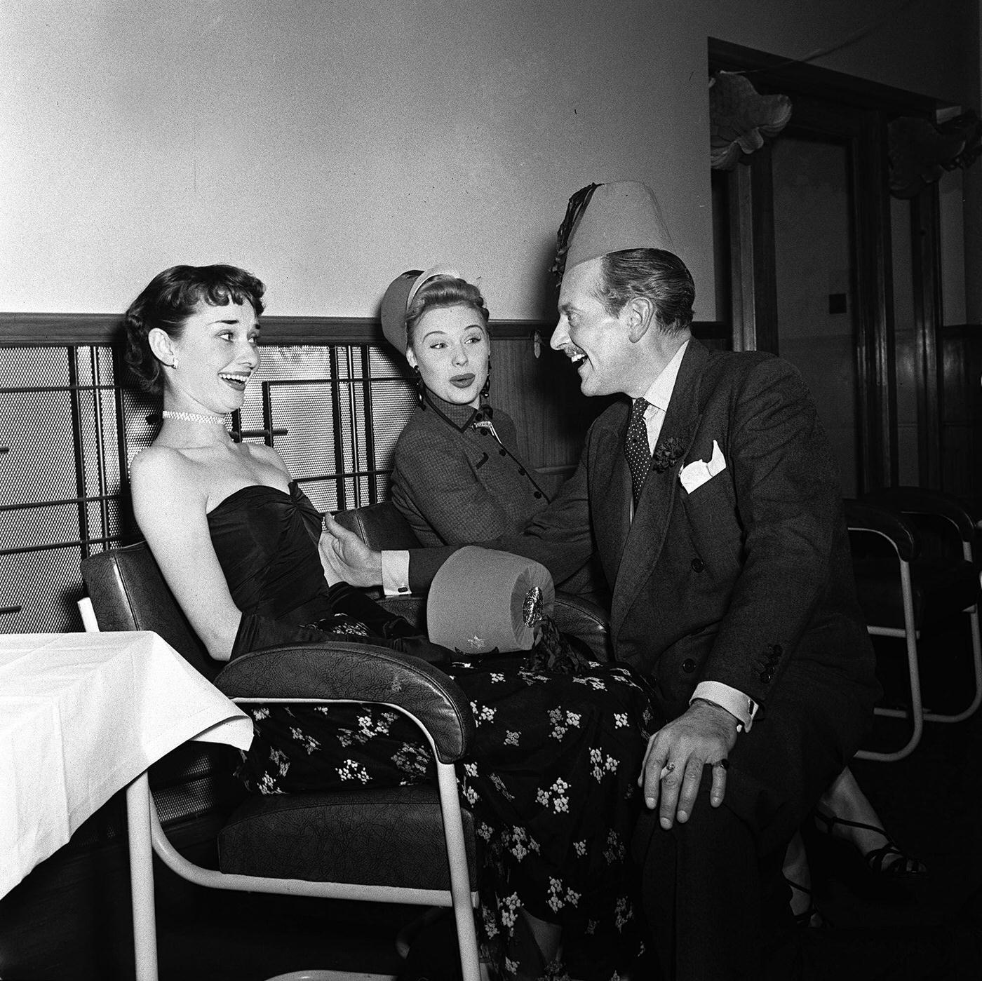 Enjoying the festivities are British actresses Audrey Hepburn (left) and Sandra Dorne, and actor Guy Middleton.