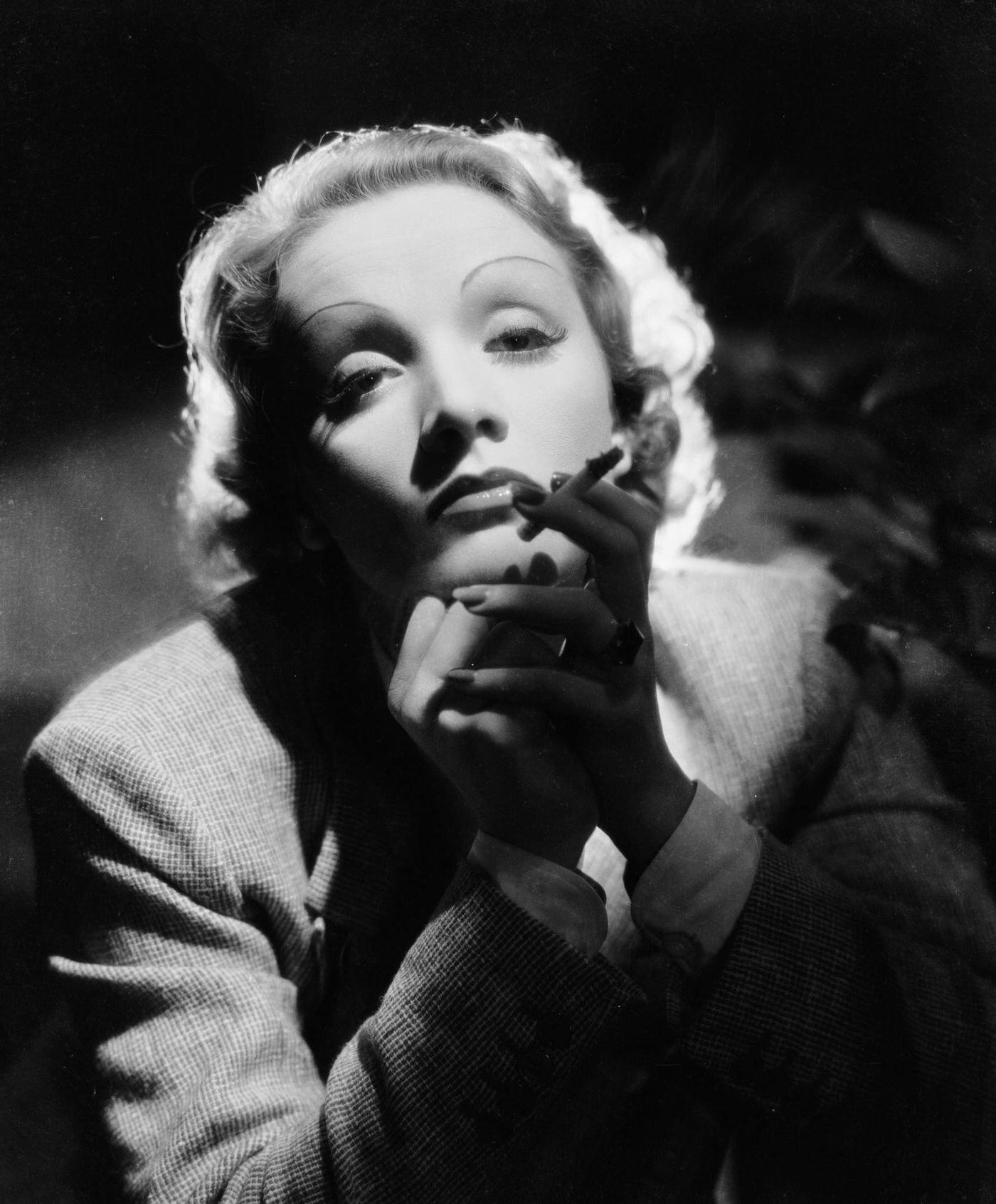 Marlene Dietrich oozes sensuality while smoking in the 1930s.