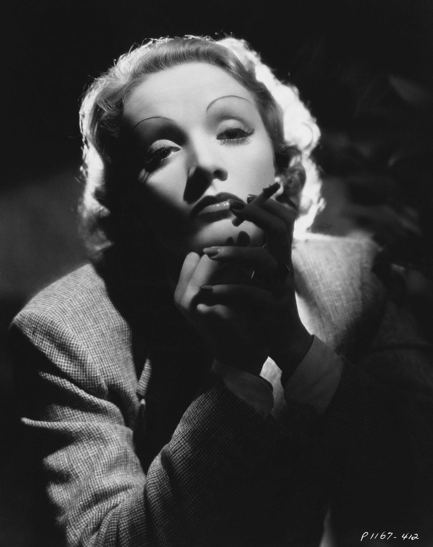 A photograph of actress Marlene Dietrich smoking taken in 1935.