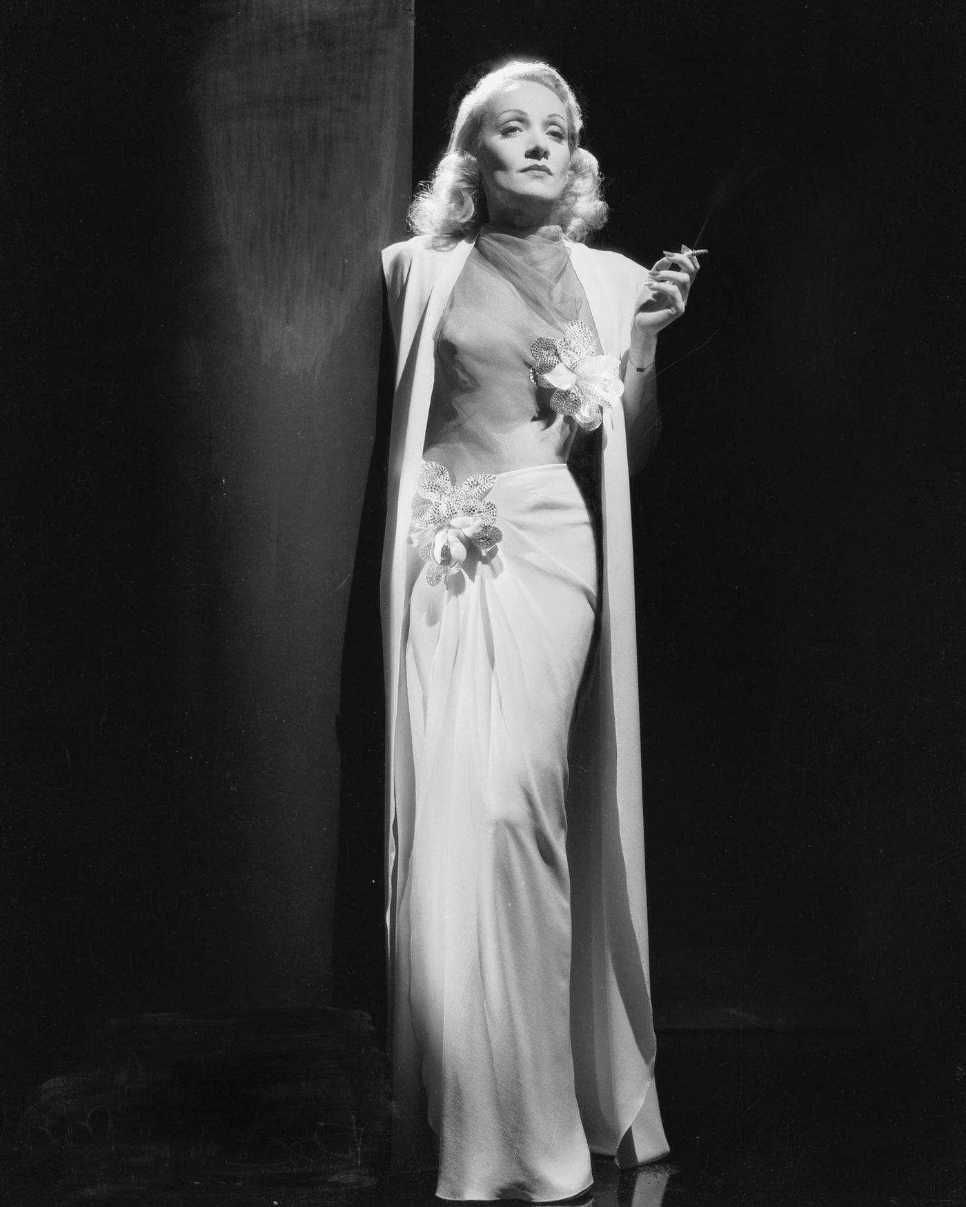 Marlene Dietrich looks stunning in an elegant white dress from 1937.