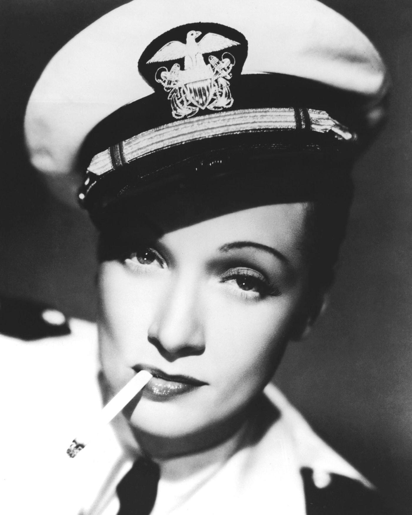 Marlene Dietrich looks stylish in a sailor's cap and cigarette in a promotional portrait for 'Seven Sinners.'