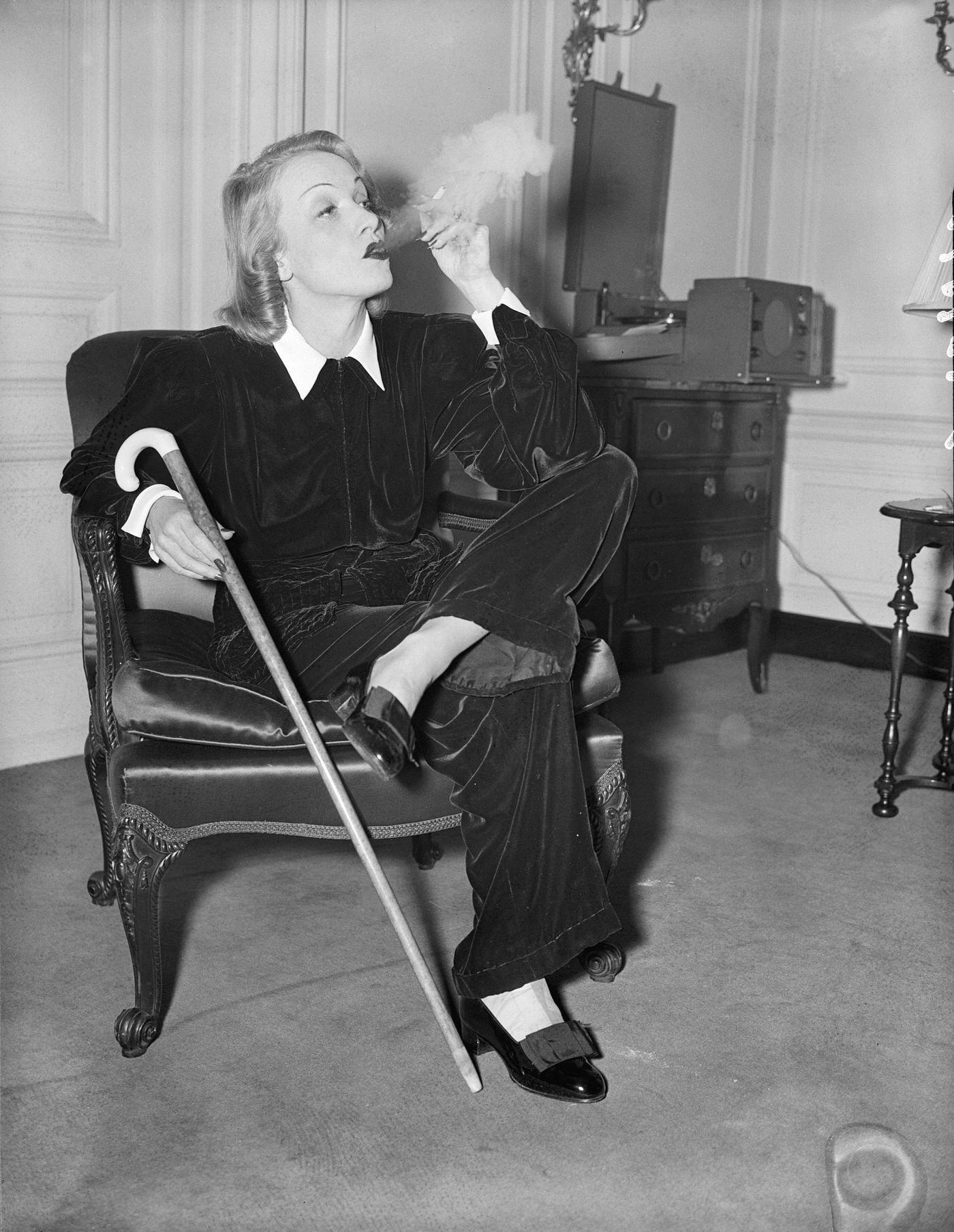 Marlene Dietrich is seen puffing a cigarette in her suite at the St. Regis Hotel.