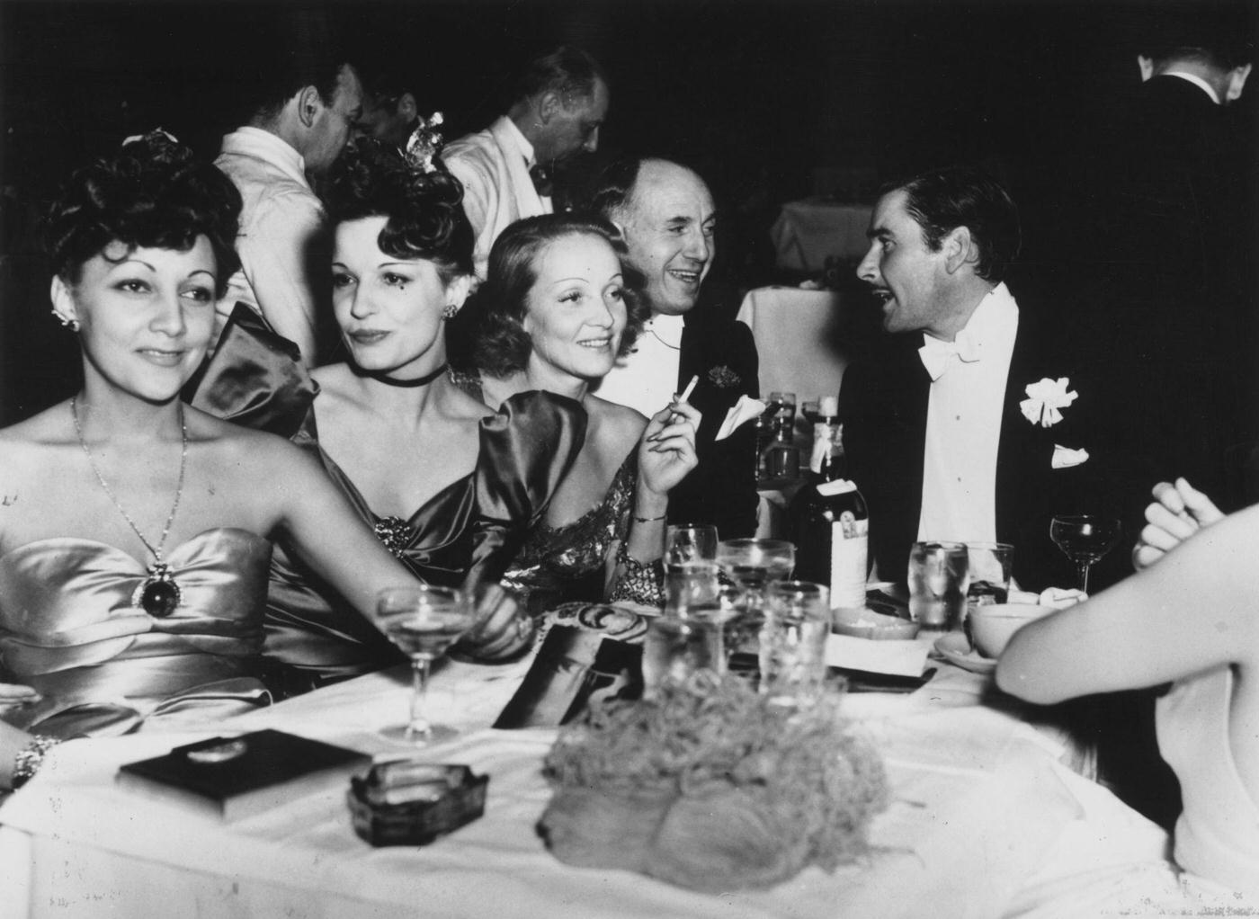 Errol Flynn, Maria Magdalena von Losch, Lili Damita, and Jack Warner are pictured with Marlene Dietrich.