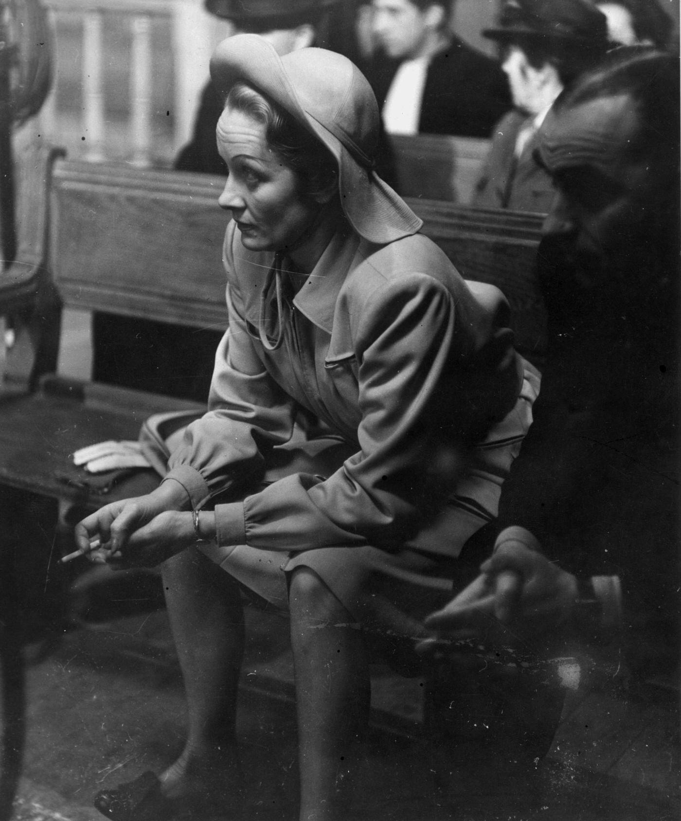 Marlene Dietrich takes a cigarette break during the filming of 'Martin Roumagnac' in 1944.