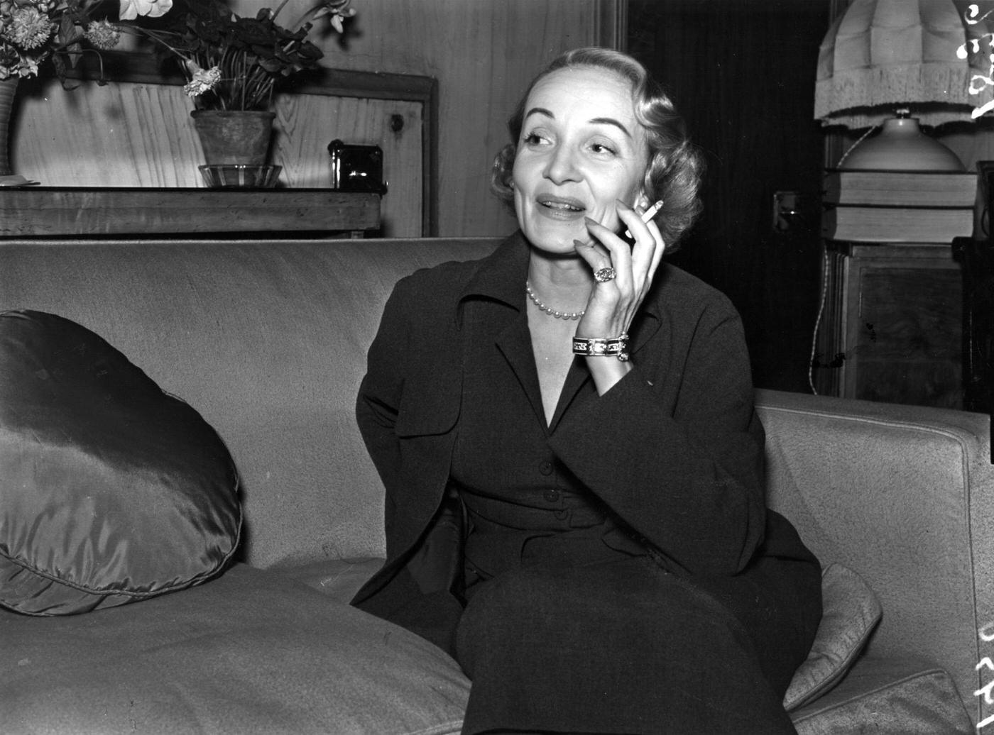 Marlene Dietrich is captured smoking in 1950.