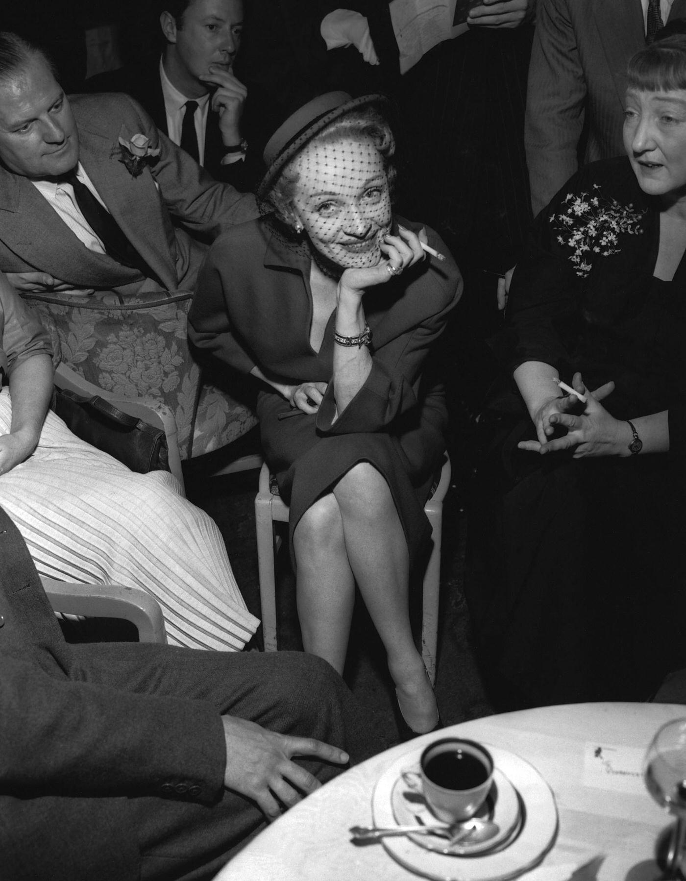 Marlene Dietrich smiles for photographers in 1954.