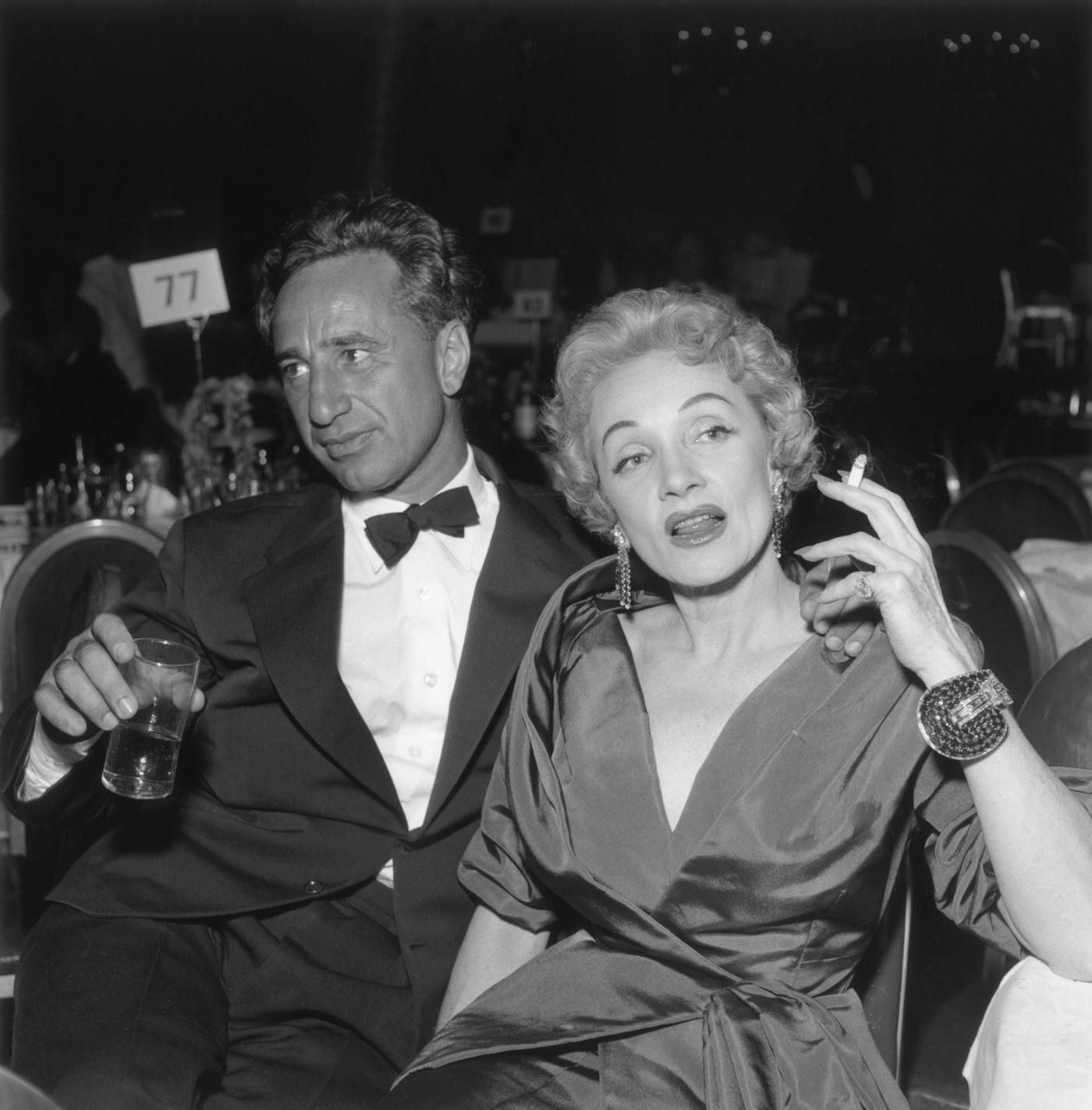 Elia Kazan and Marlene Dietrich sit together at the premiere reception for director George Cukor's film 'A Star is Born' in the 1950s.