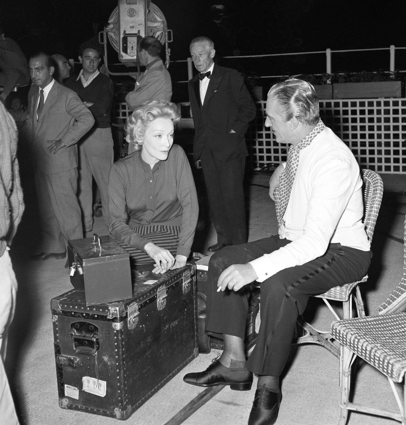 Marlene Dietrich and Vittorio De Sica chat during a break on the set of 'The Monte Carlo Story.'