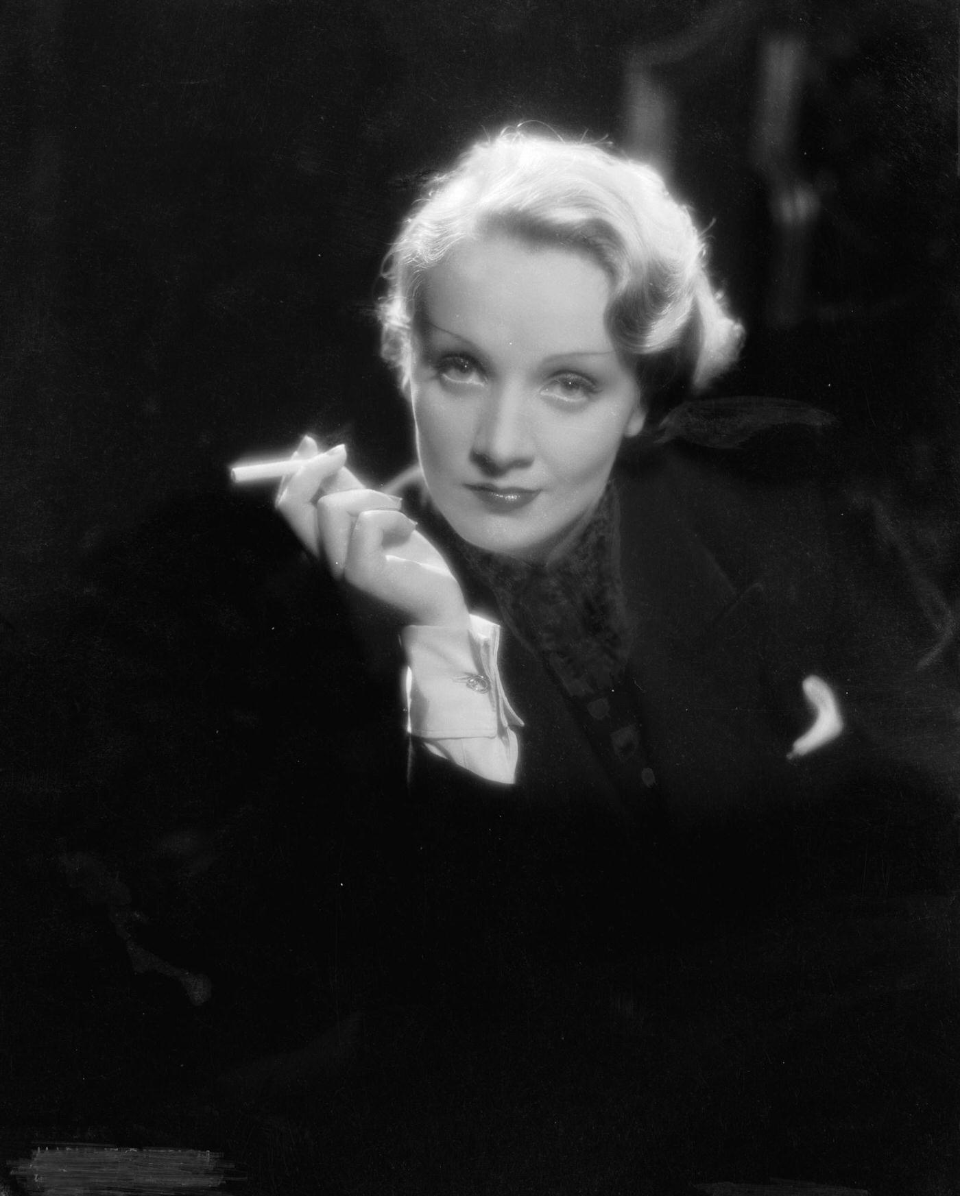Marlene Dietrich captured smoking in a photograph.