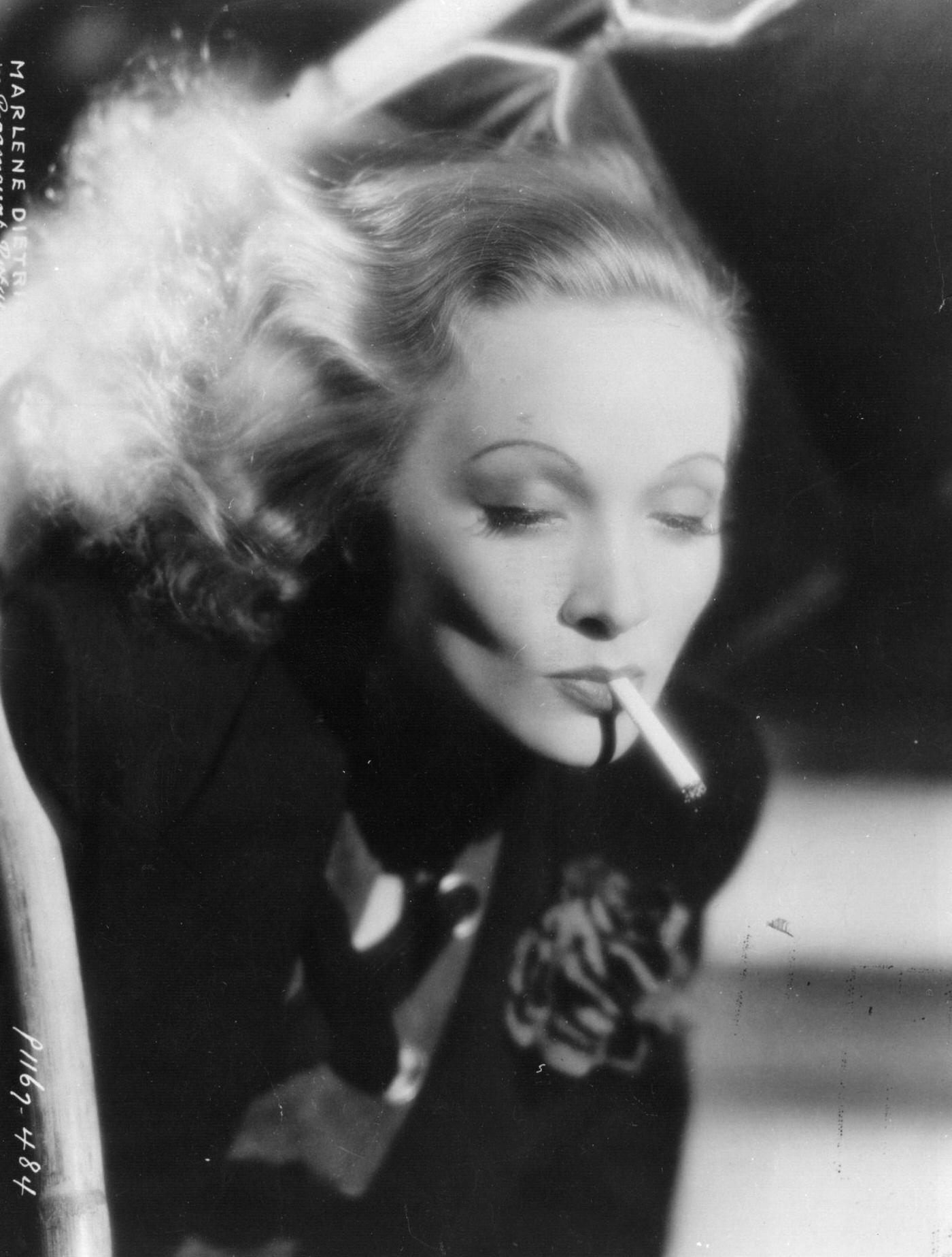 A photograph of Marlene Dietrich smoking taken in 1932.