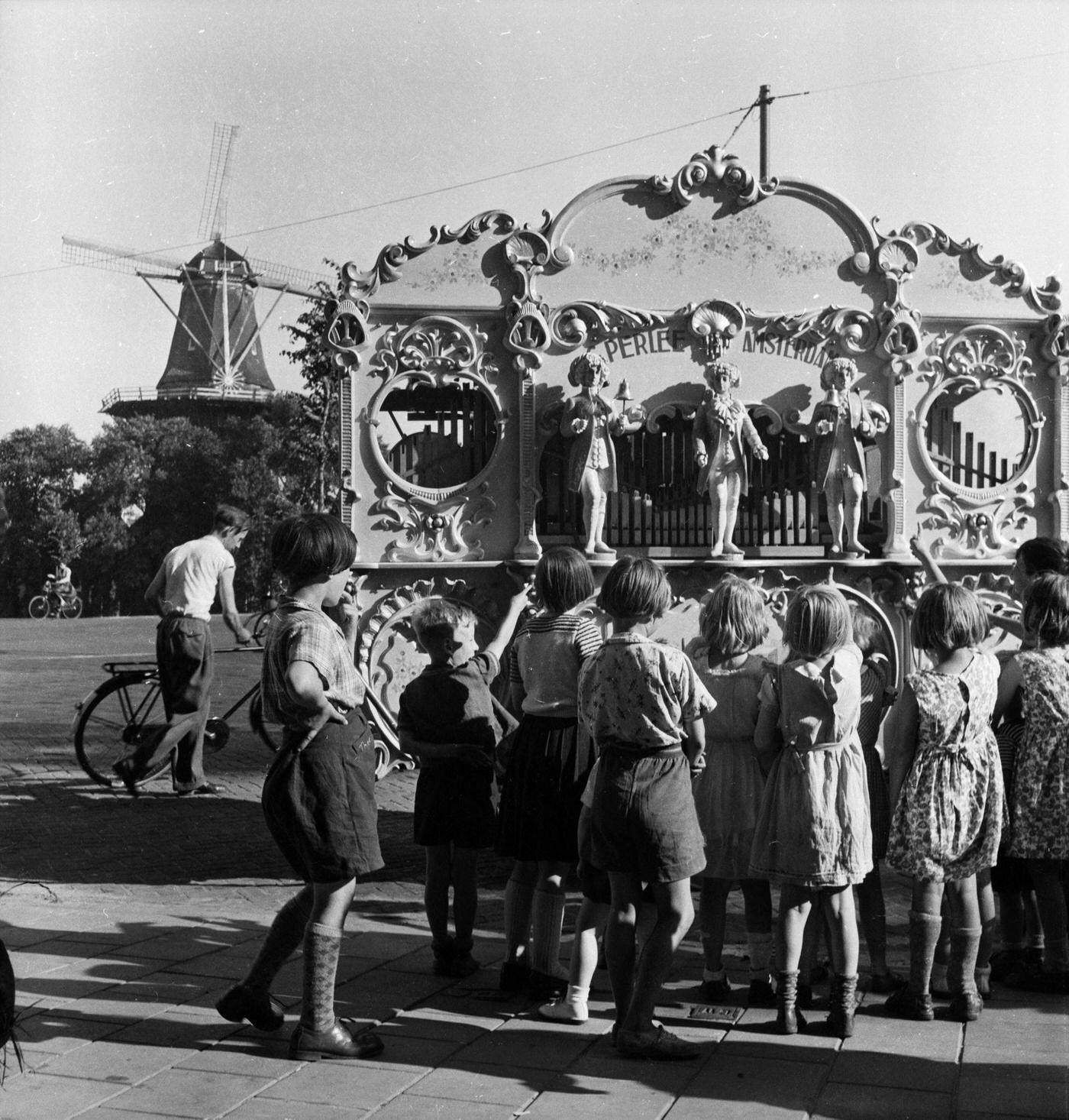 Only three organ-grinders licensed to take an organ into the main streets of Amsterdam, compared to about fifty before the war, 1955.