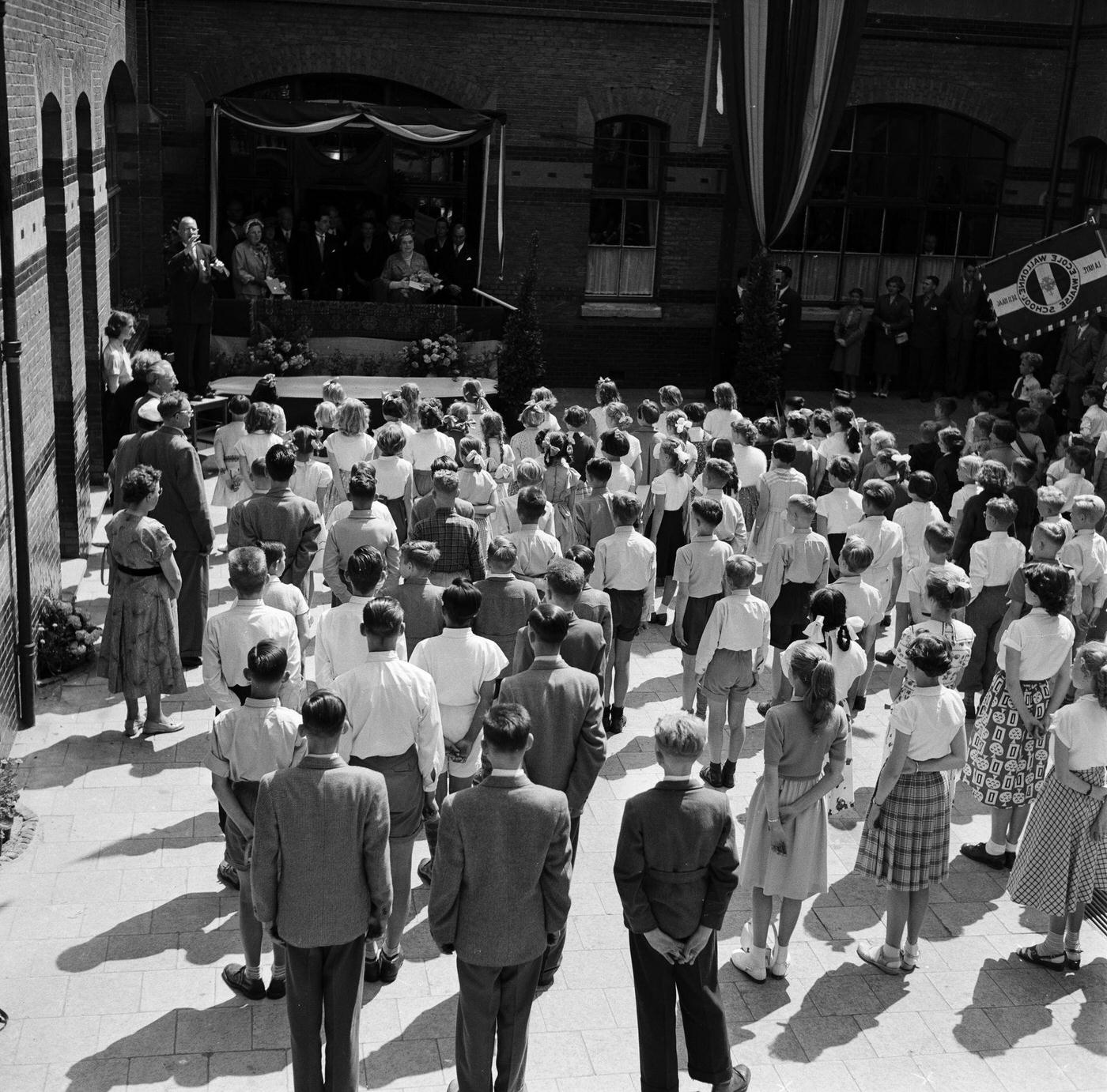 René Coty in Holland, 3rd March 1955. The President of the French Republic, René Coty and his wife, on a visit to Holland. Mrs Coty is seen on a balcony in front of children lined up in a courtyard.