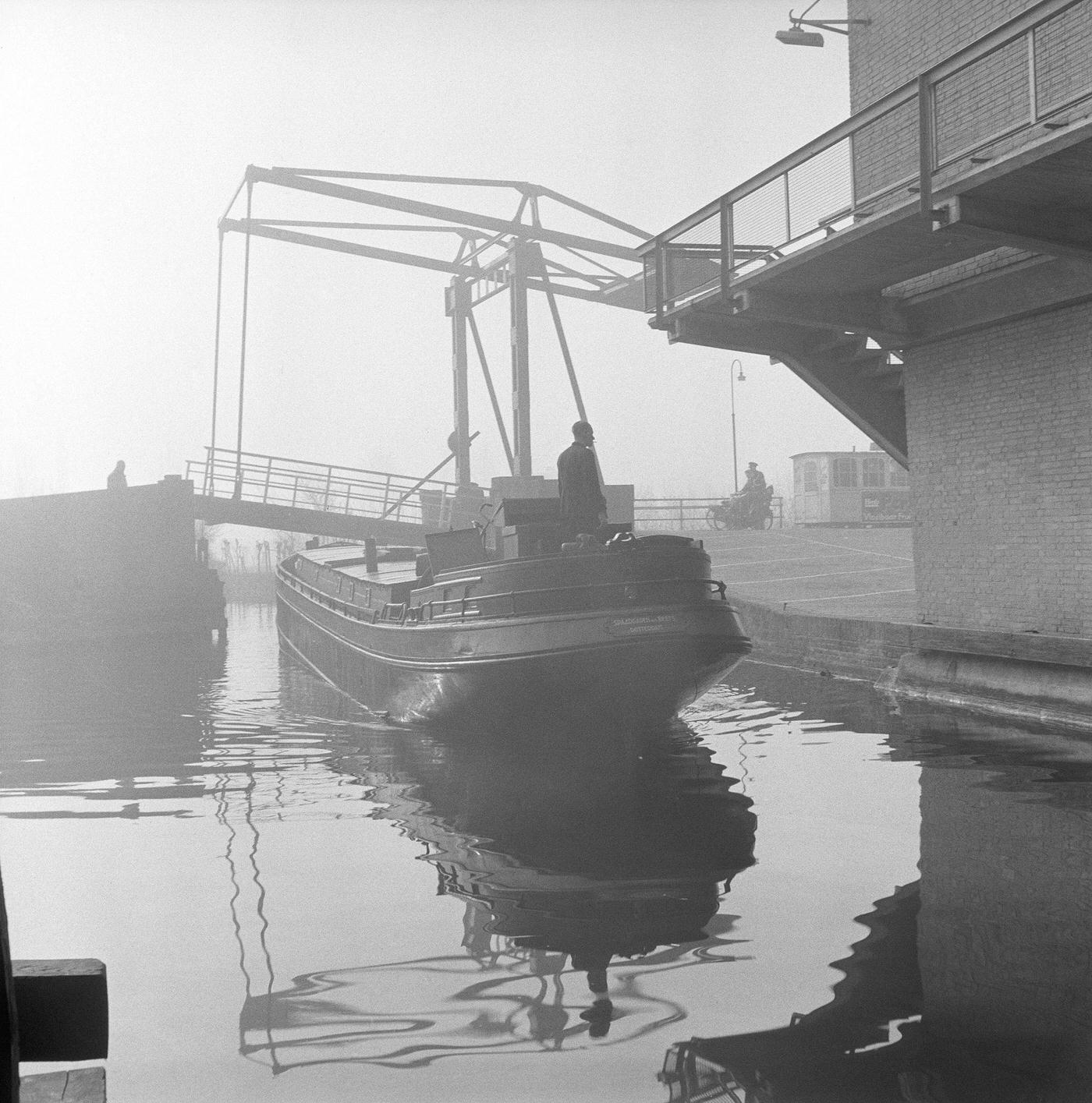 A boat passing under a drawbridge in the Netherlands, 1954.