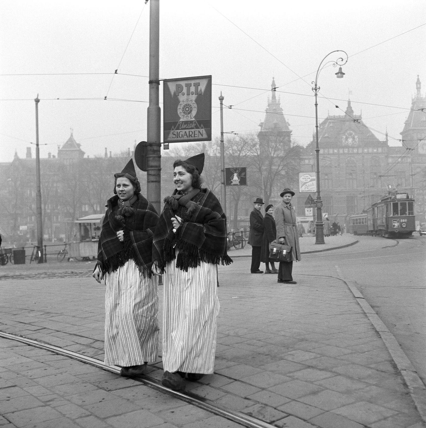 Two young Dutch women walking near the central station, Amsterdam, the Netherlands, 1954.