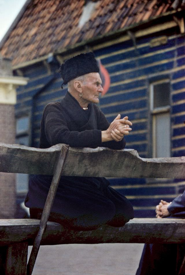 Man in traditional clothing and with a golden earring, Volendam.