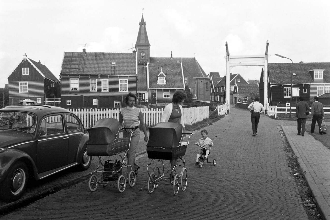 Scene in the street De Pieterlanden with a view of the belfry of Grote Kerk church on Marken island, The Netherlands in 1971.
