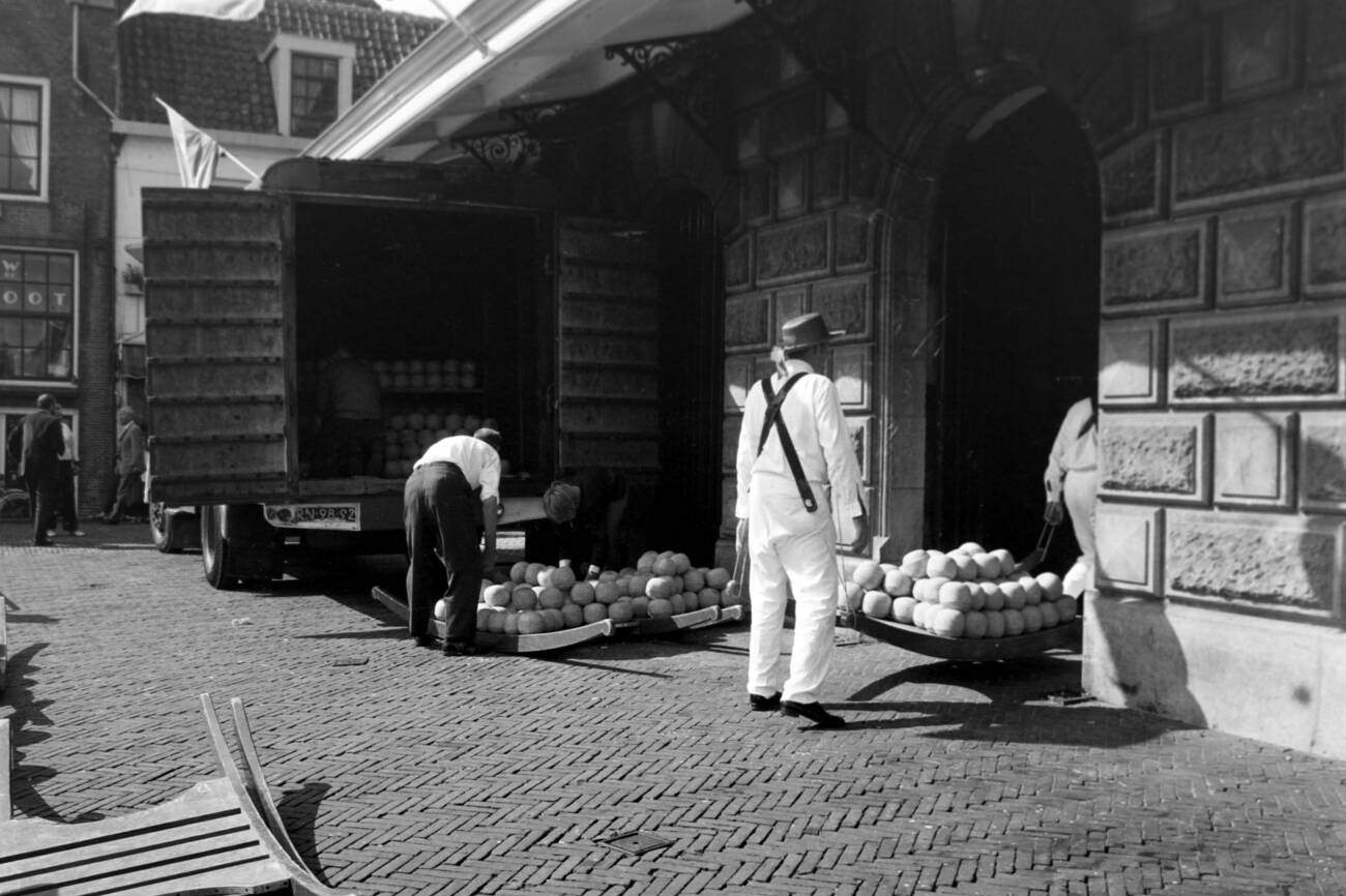 Cheese carriers at the cheese market in front of the city weigh building De Waag at Alkmaar, The Netherlands in 1971.