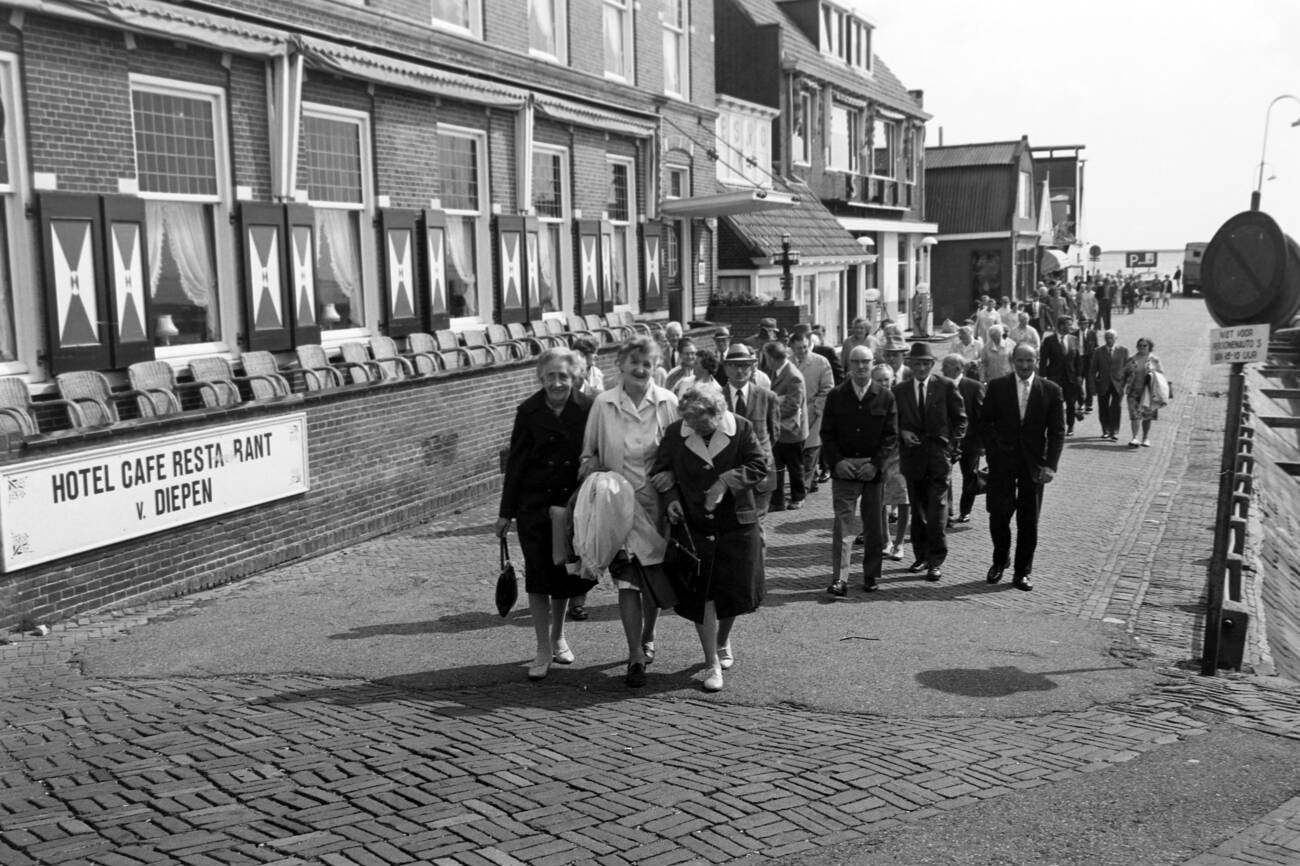 Tourists hurrying to the landing at Volendam harbor for a day trip to Marken island, The Netherlands in 1971