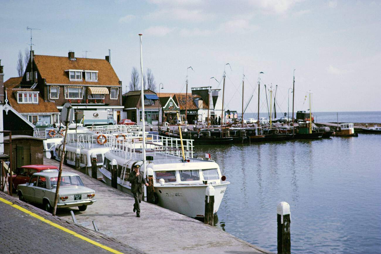 Volendam, Netherlands in 1973: Tourist boats and fishing boats side by side at the quayside of Volendam.