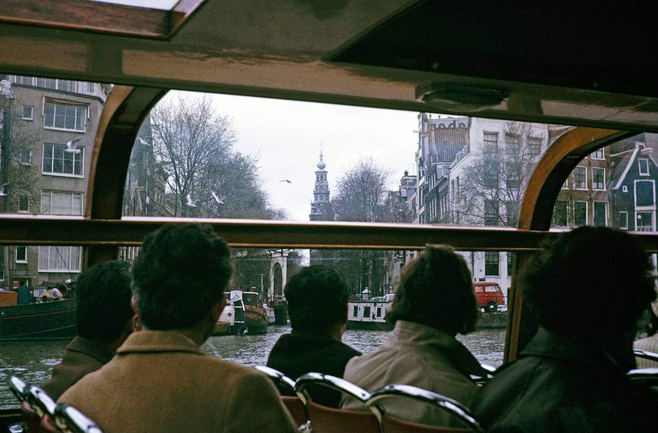 Boat trip tour of the city center Amsterdam, Netherlands 1973: People enjoying a boat trip tour of the city center of Amsterdam in 1973.