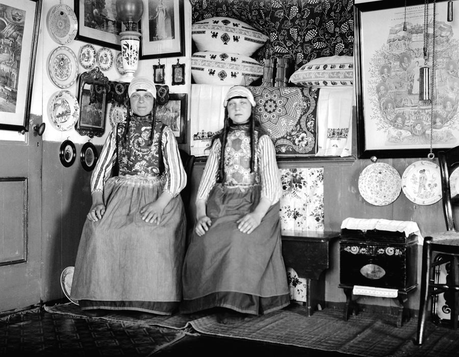 Two girls dressed in traditional Marken costume in a typical Marken fisherman's cottage. Marken was an island, now joined to the mainland, just Northwest of Amsterdam.