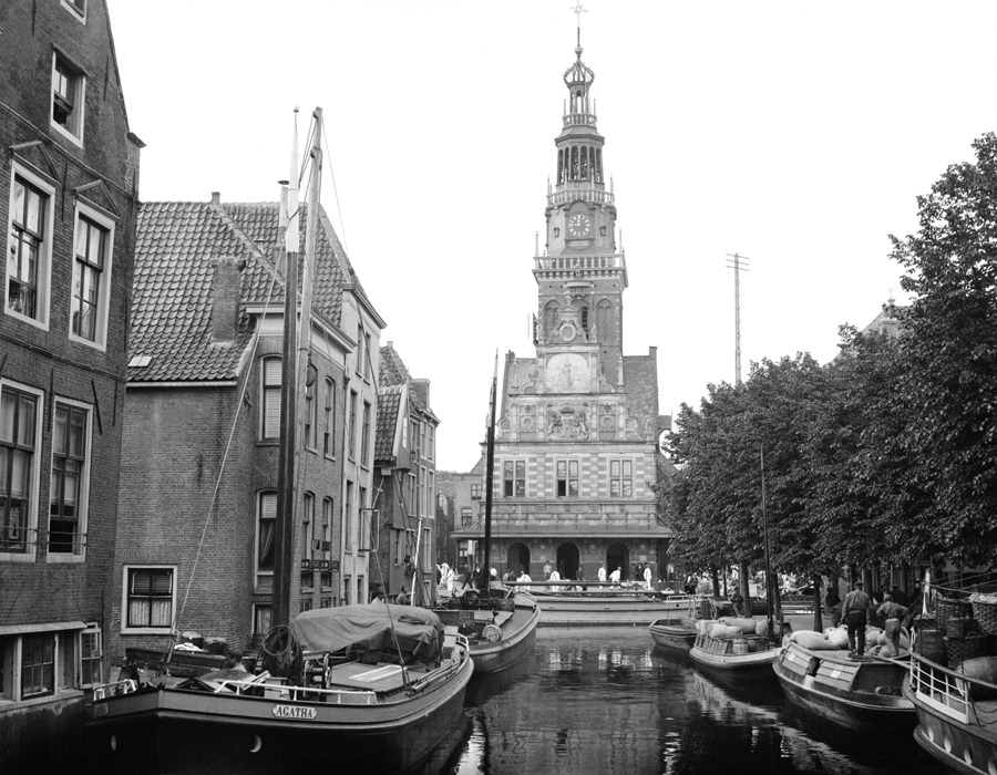 Canal and cheese market in Alkmaar. Alkmaar is noted for its open-air cheese market, barely visible on the plaza ahead.