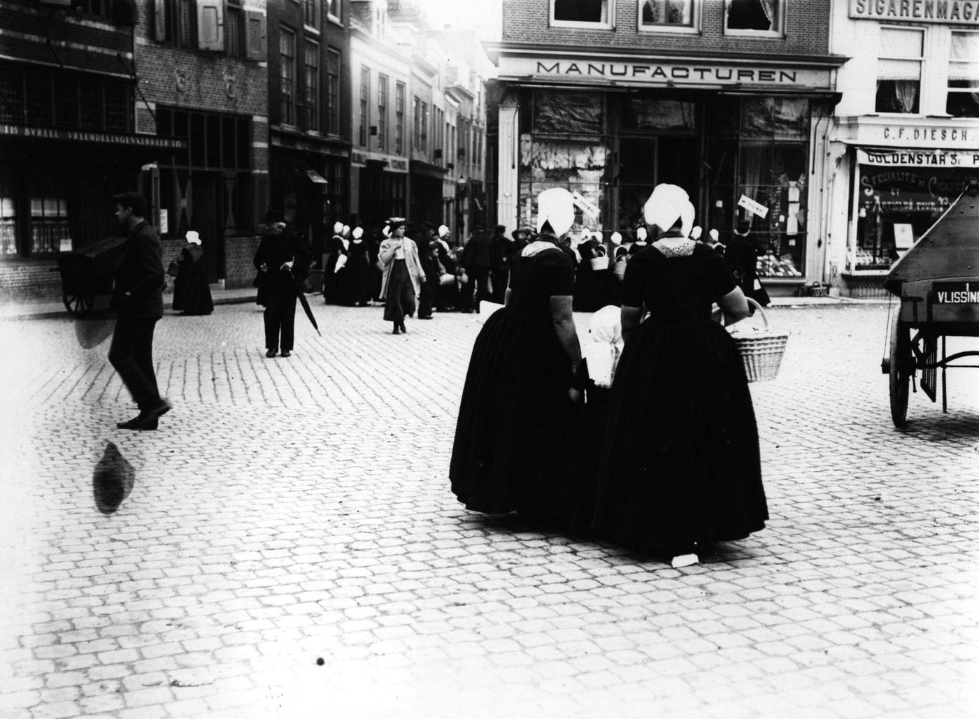 Women shopping in a Dutch town, Netherlands, 1900.