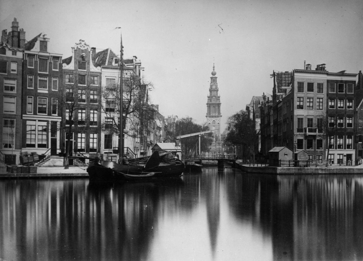 A barge moored alongside a canal in the Dutch city of Amsterdam, 1900