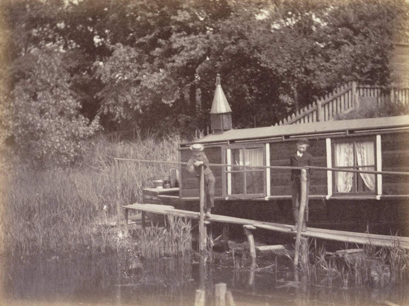 Two boys on a jetty for a houseboat in Amsterdam, The Netherlands, 1900s