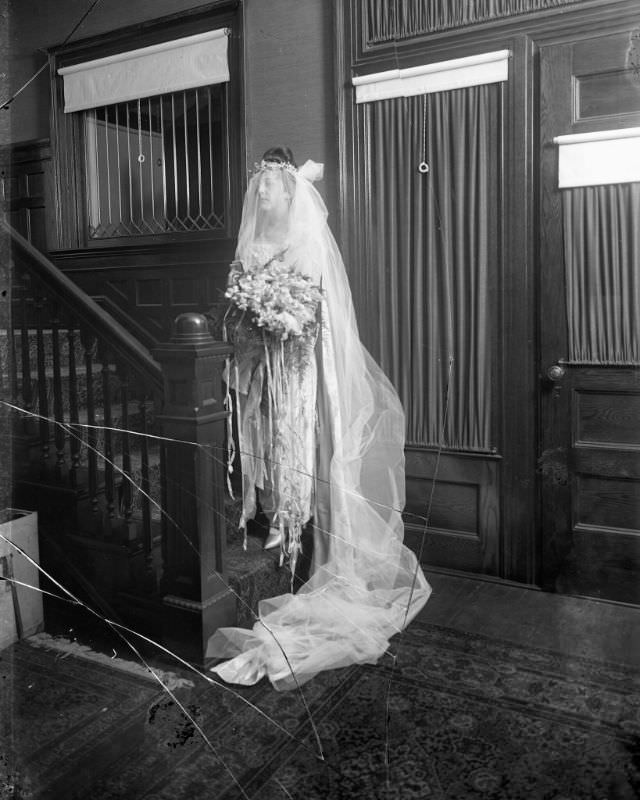 Portrait of a bride at the bottom of residential stairs, 1915
