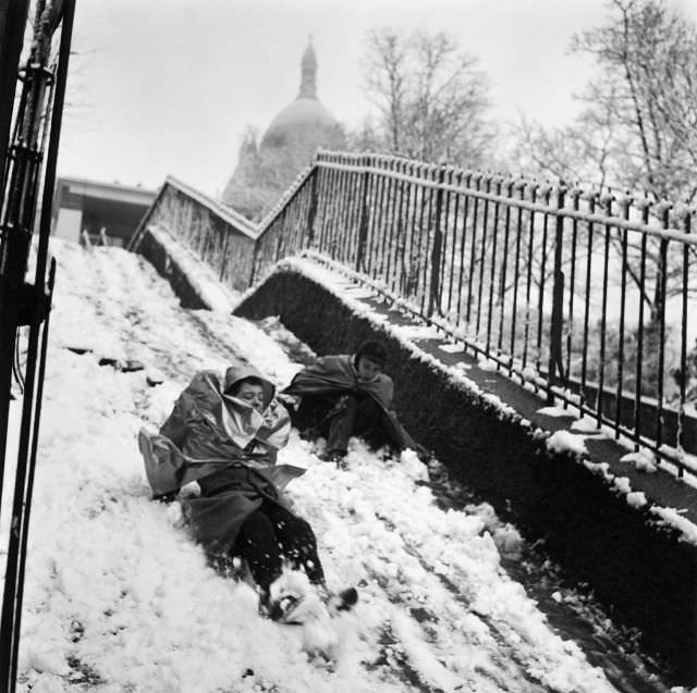 Boys sliding down in Montmartre in winter, 1958. (Robert Doisneau)