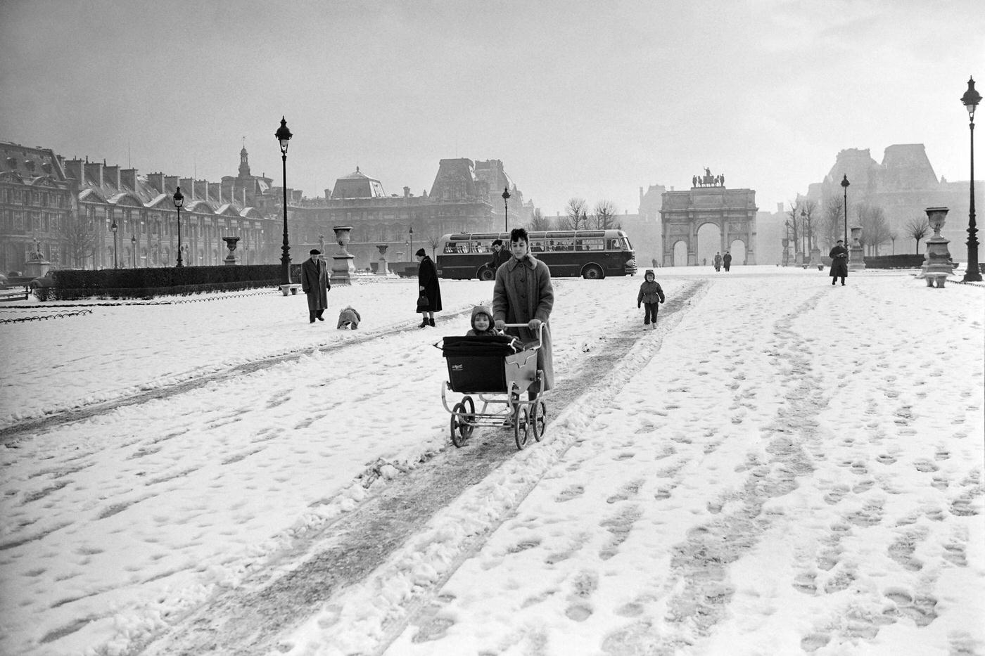 Woman Pushing a Pram In Jardin des Tuileries, Paris, February 13, 1956.