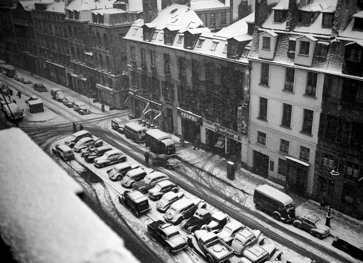 People Walking In The Muddy Snow In Paris During The 1952 Winter.